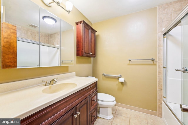 full bathroom featuring tile patterned flooring, combined bath / shower with glass door, toilet, and vanity