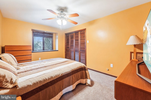 bedroom with carpet, a closet, and ceiling fan