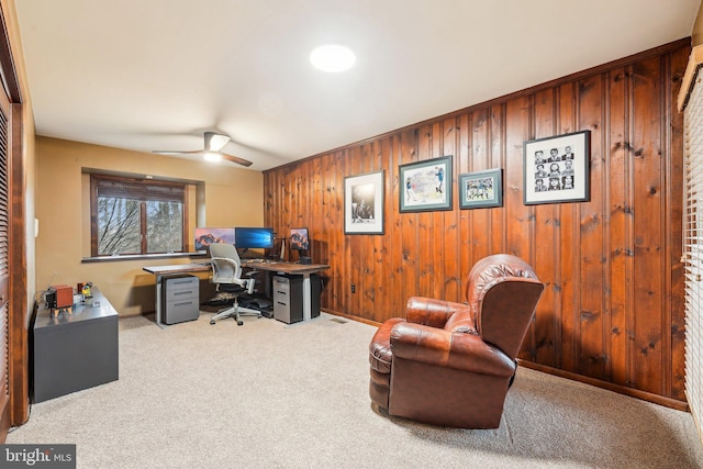 carpeted office featuring ceiling fan