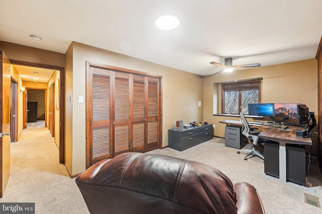 office with light carpet and ceiling fan