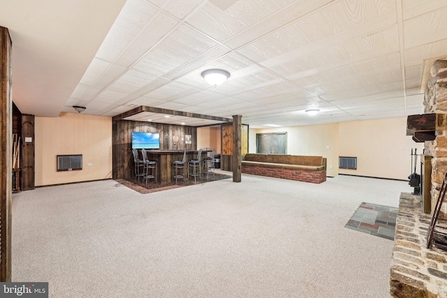 basement featuring carpet floors and indoor bar