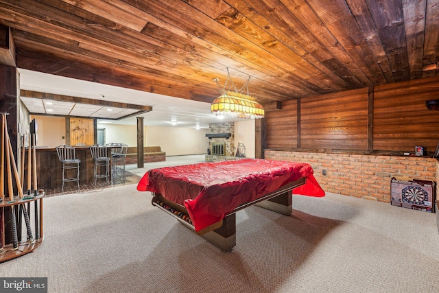 recreation room featuring brick wall, pool table, bar, carpet floors, and wood ceiling