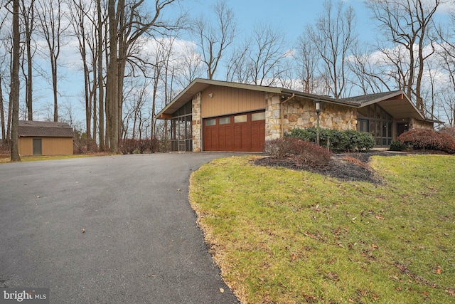 view of front of home with a garage and a front lawn