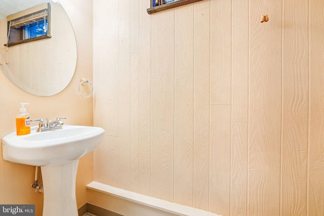 bathroom featuring wood walls