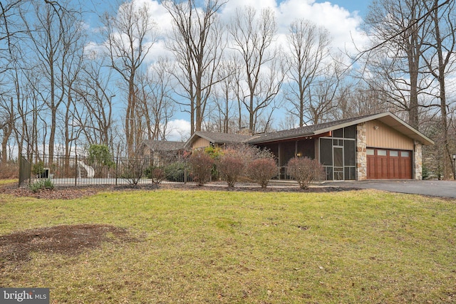 view of front of property with a garage and a front yard