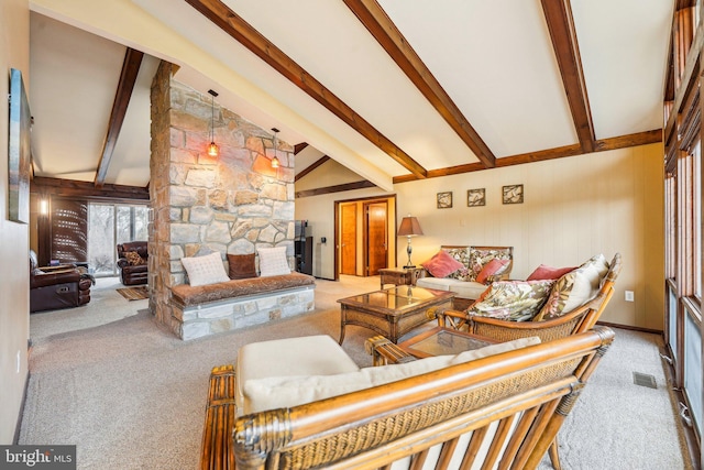 carpeted living room featuring a fireplace, beamed ceiling, and high vaulted ceiling