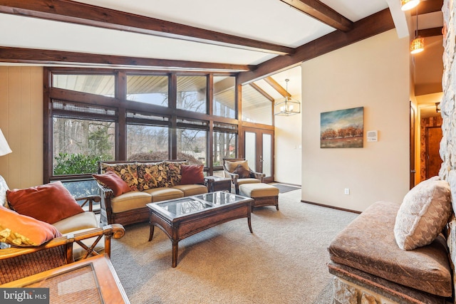 living room featuring vaulted ceiling with beams, a notable chandelier, and carpet floors