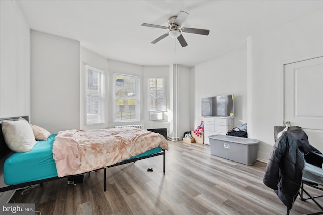 bedroom with light hardwood / wood-style floors and ceiling fan