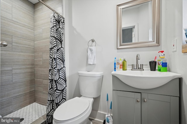 bathroom with vanity, toilet, and walk in shower