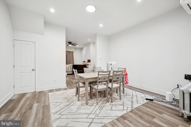 dining space with ceiling fan and light hardwood / wood-style flooring