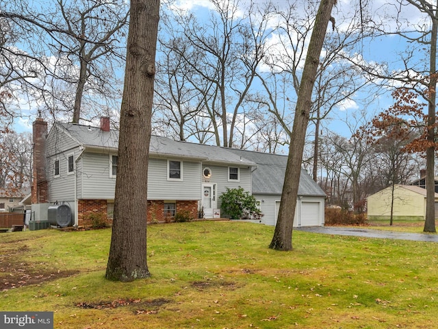 bi-level home featuring a front yard and a garage