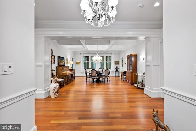 foyer featuring an inviting chandelier, coffered ceiling, beam ceiling, and light wood-type flooring