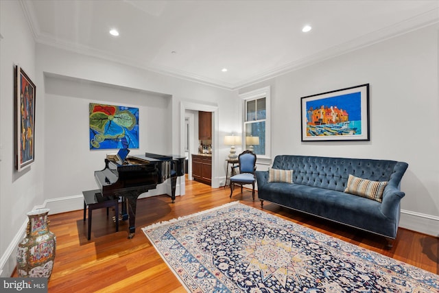 living room with wood-type flooring and crown molding