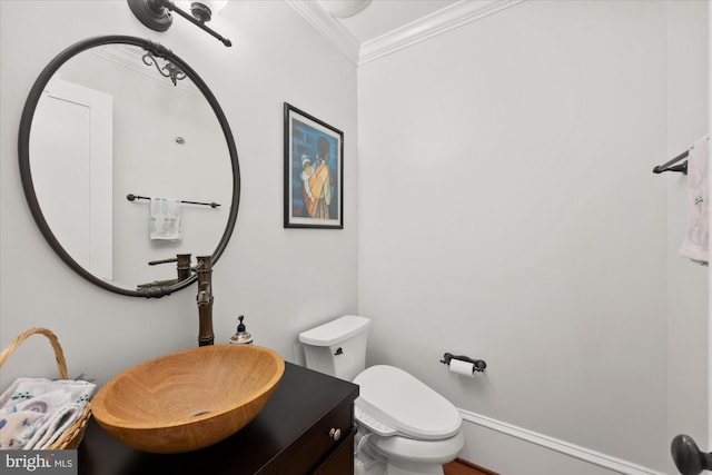 bathroom featuring ornamental molding, toilet, and vanity