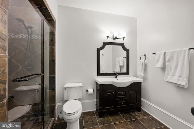 bathroom featuring vanity, toilet, and walk in shower