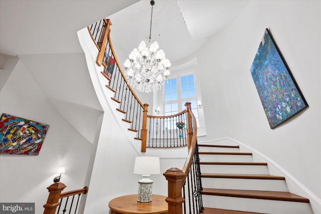 stairs featuring a chandelier