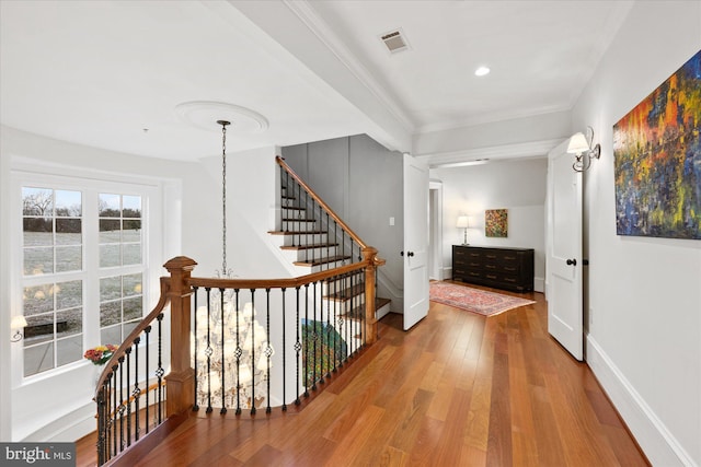 hall featuring crown molding and hardwood / wood-style flooring