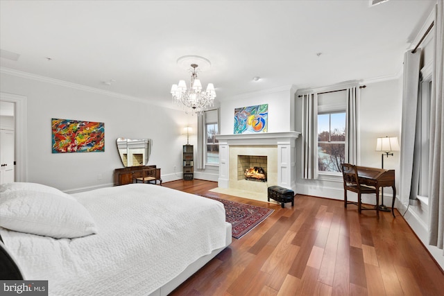 bedroom with crown molding, hardwood / wood-style flooring, and a chandelier