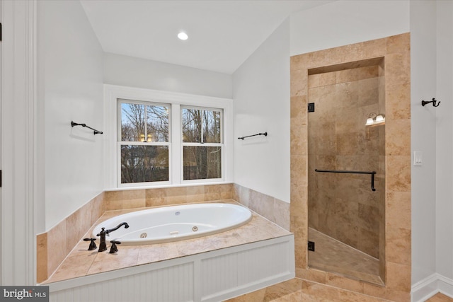 bathroom featuring shower with separate bathtub