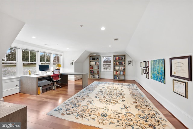 home office with lofted ceiling and light wood-type flooring