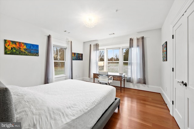 bedroom with wood-type flooring