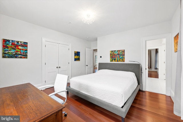 bedroom featuring dark hardwood / wood-style floors and a closet