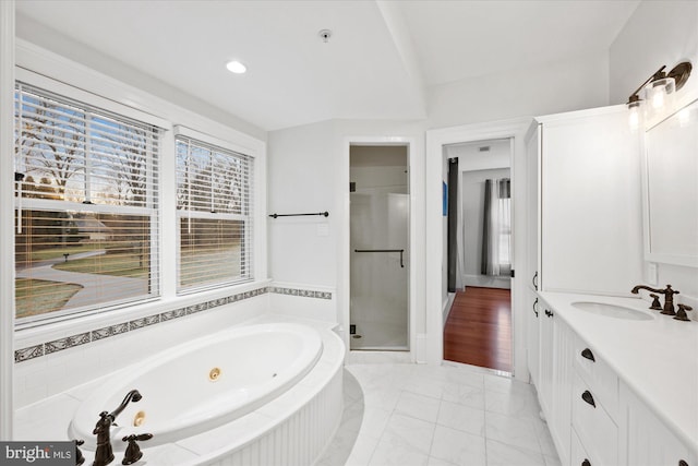 bathroom with vanity and separate shower and tub