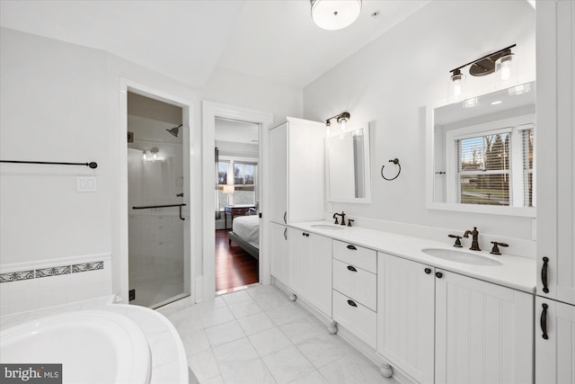 bathroom featuring plus walk in shower, a wealth of natural light, and vanity