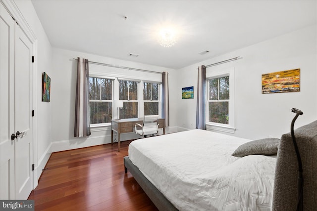 bedroom with dark wood-type flooring