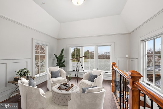 living area featuring hardwood / wood-style flooring, vaulted ceiling, and a wealth of natural light