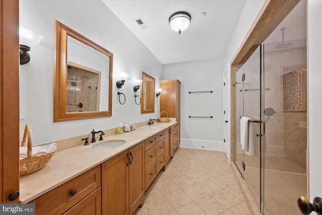 bathroom with vanity and a shower with door