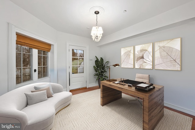 office area featuring an inviting chandelier and light wood-type flooring