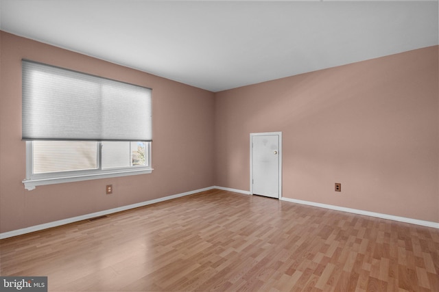 spare room with light wood-type flooring