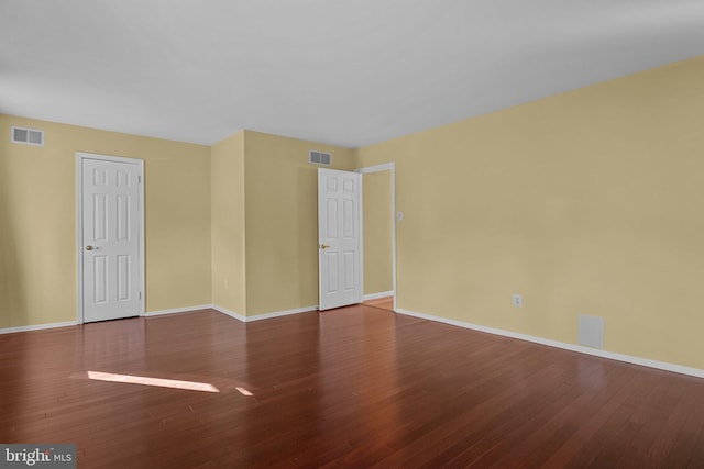 spare room with hardwood / wood-style flooring