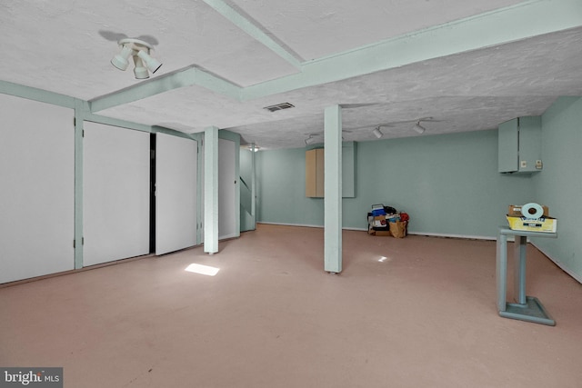 basement featuring a textured ceiling