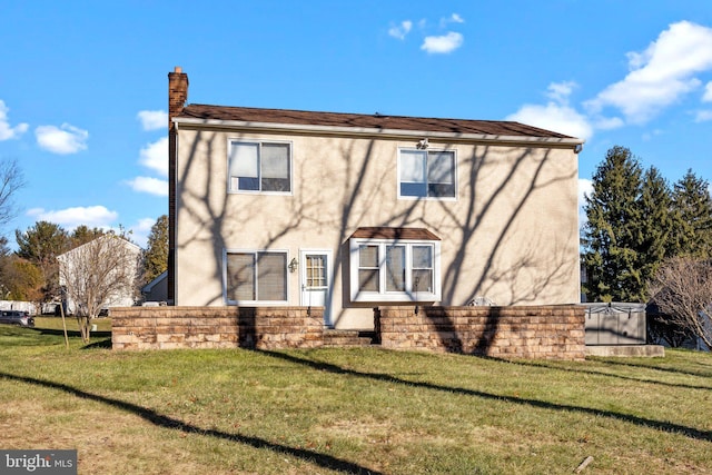 back of property featuring a lawn