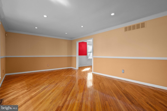 empty room with light hardwood / wood-style flooring and ornamental molding