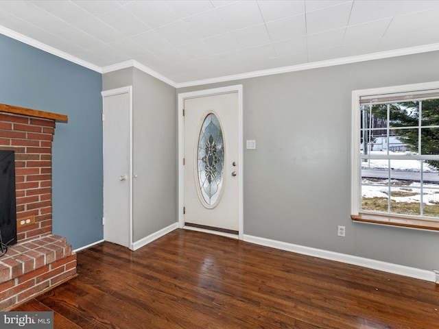 entryway featuring a fireplace, ornamental molding, and dark hardwood / wood-style floors