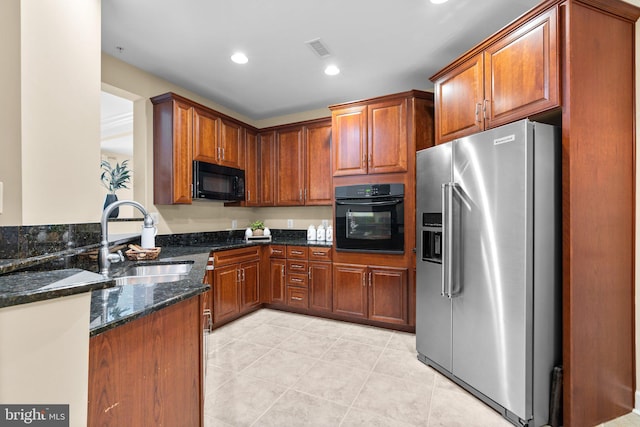 1915 Towne Centre Blvd Unit 502, Annapolis, MD 21401 - kitchen with black appliances, dark stone counters, brown cabinetry, and recessed lighting