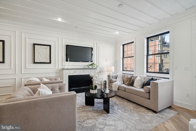 living room featuring light wood-type flooring and ornamental molding