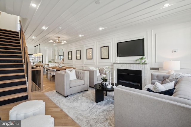 living room with light wood-type flooring and wooden ceiling