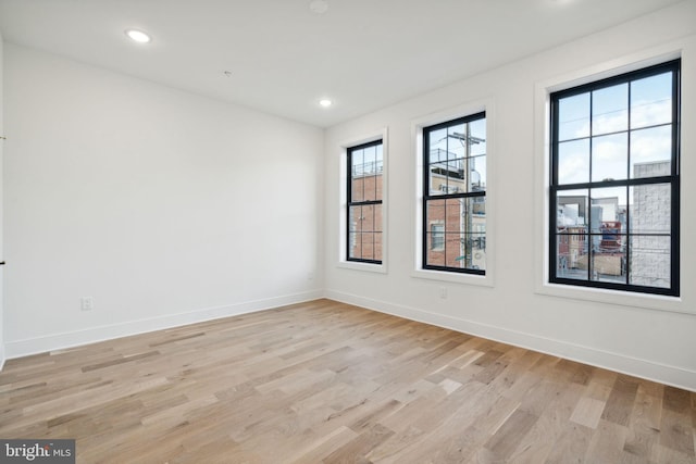 empty room with light hardwood / wood-style floors