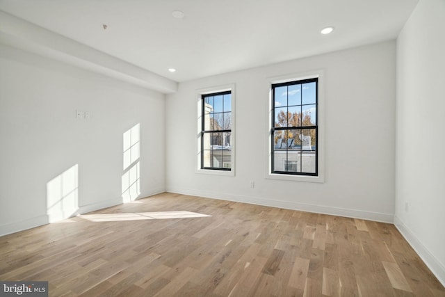 unfurnished room with light wood-type flooring