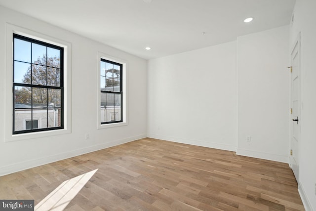 spare room featuring light wood-type flooring