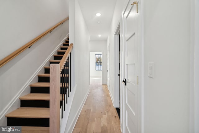 staircase with hardwood / wood-style flooring