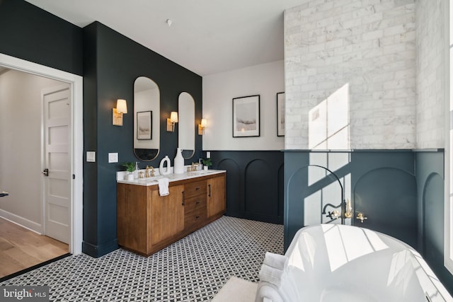 bathroom featuring vanity, wood-type flooring, and a tub