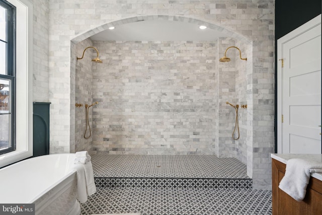 bathroom with vanity and independent shower and bath