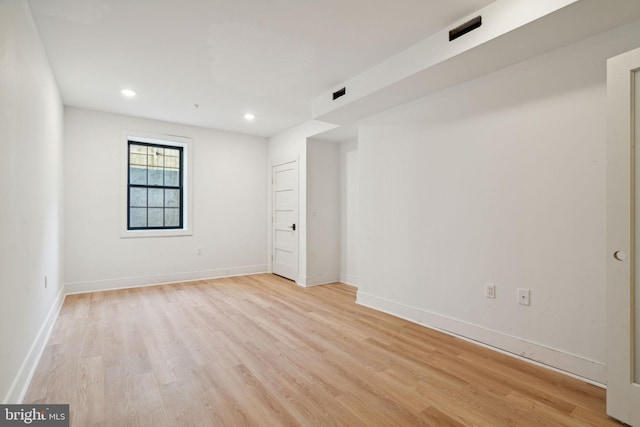 spare room featuring light hardwood / wood-style flooring