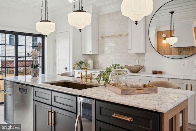 kitchen with white cabinets, decorative light fixtures, light stone counters, and dishwasher