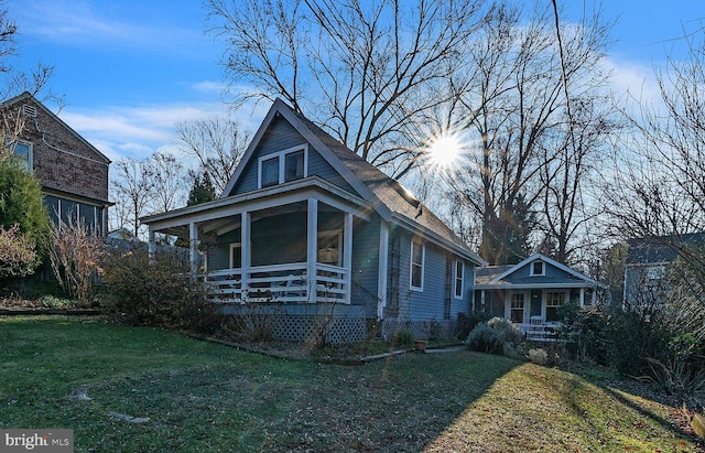 bungalow with a porch and a front yard